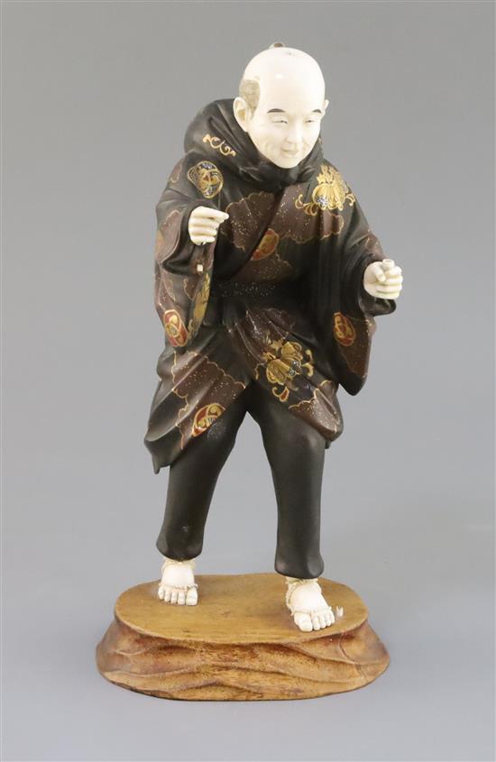 A Japanese lacquer and ivory okimono of a man, Taisho period, 1920s, H. 29cm, parts lacking